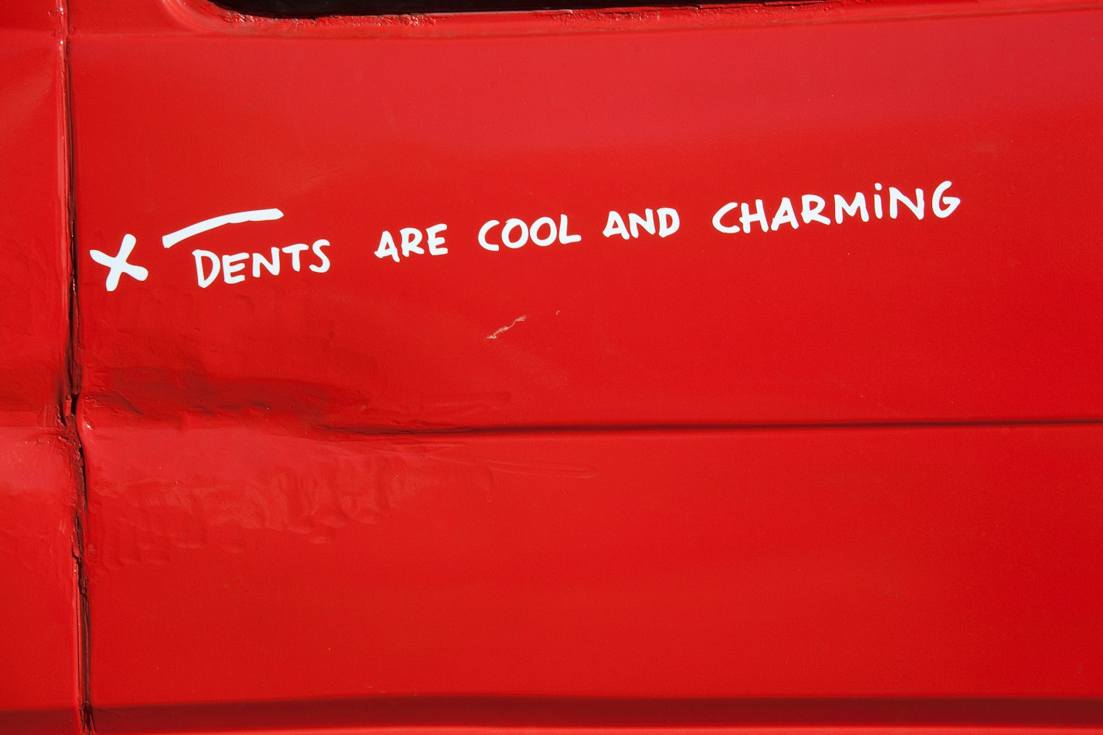 a sticker on the side of a red vehicle