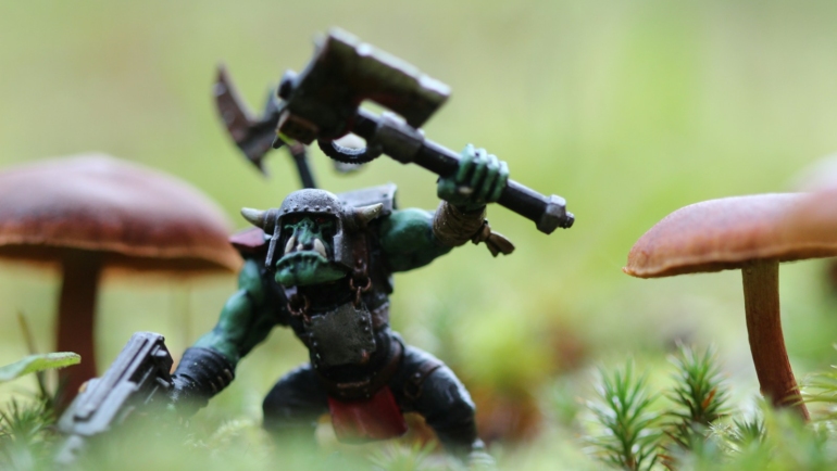 closeup photography of monster with axe action figure